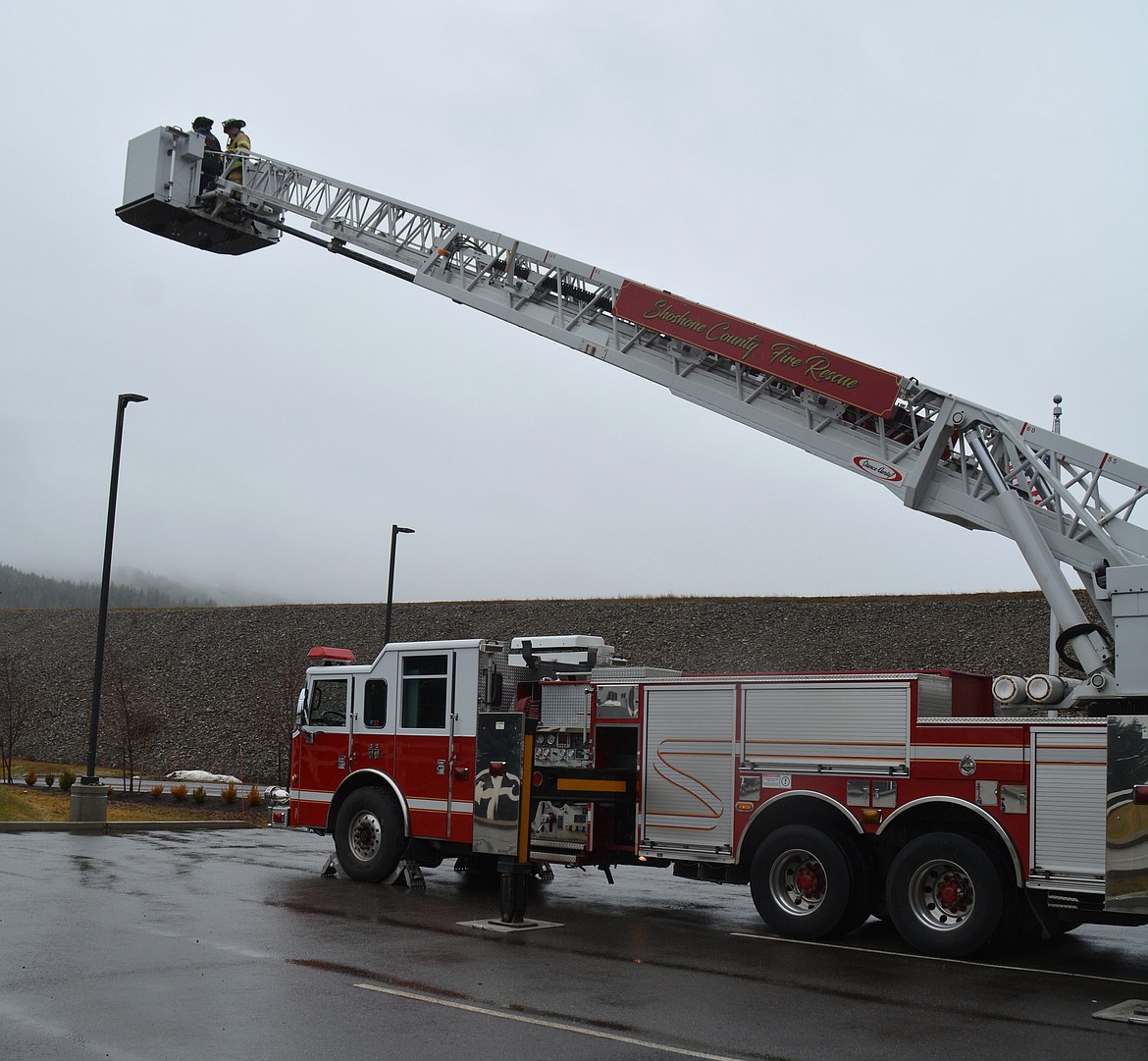 Abe Hanna and Averie Kinsey deploy Shoshone County's new ladder truck to its 100-feet span at Shoshone Fire District No. 2.