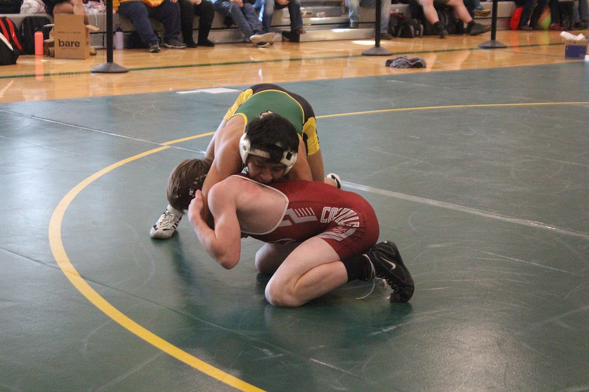 Quincy’s Saidt Alvarez, in green, qualified for Mat Classic 2024 with a third-place finish at regionals.