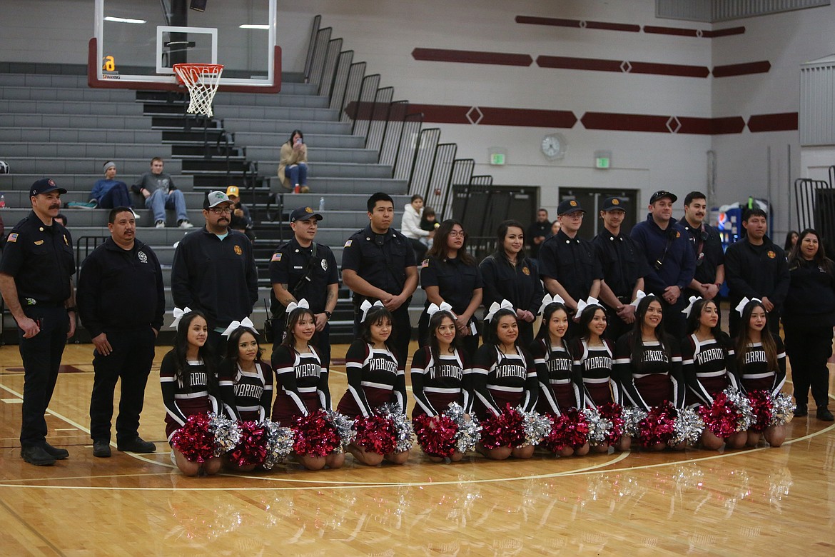 First responders pose for a picture with the Wahluke High School cheerleaders during a presentation Thursday to recognize the response to a collision that knocked over a Wahluke School District bus.