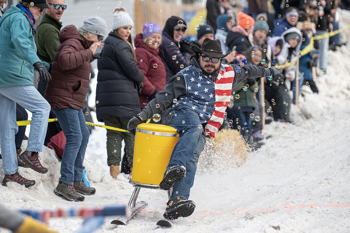 Bar stool ski racers make their way down Sugar Hill in Martin City for Cabin Fever Days Saturday, Feb. 10. Fifty-six racers participated, and an estimated $10,000-plus was raised for Badrock Canyon first responders. (Avery Howe photo)