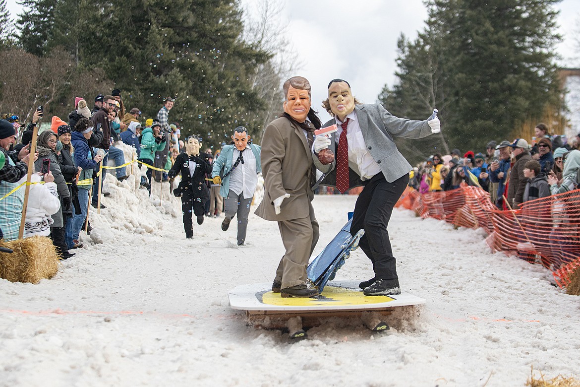 Bar stool ski racers make their way down Sugar Hill in Martin City for Cabin Fever Days Saturday, Feb. 10. Fifty-six racers participated, and an estimated $10,000-plus was raised for Badrock Canyon first responders. (Avery Howe photo)