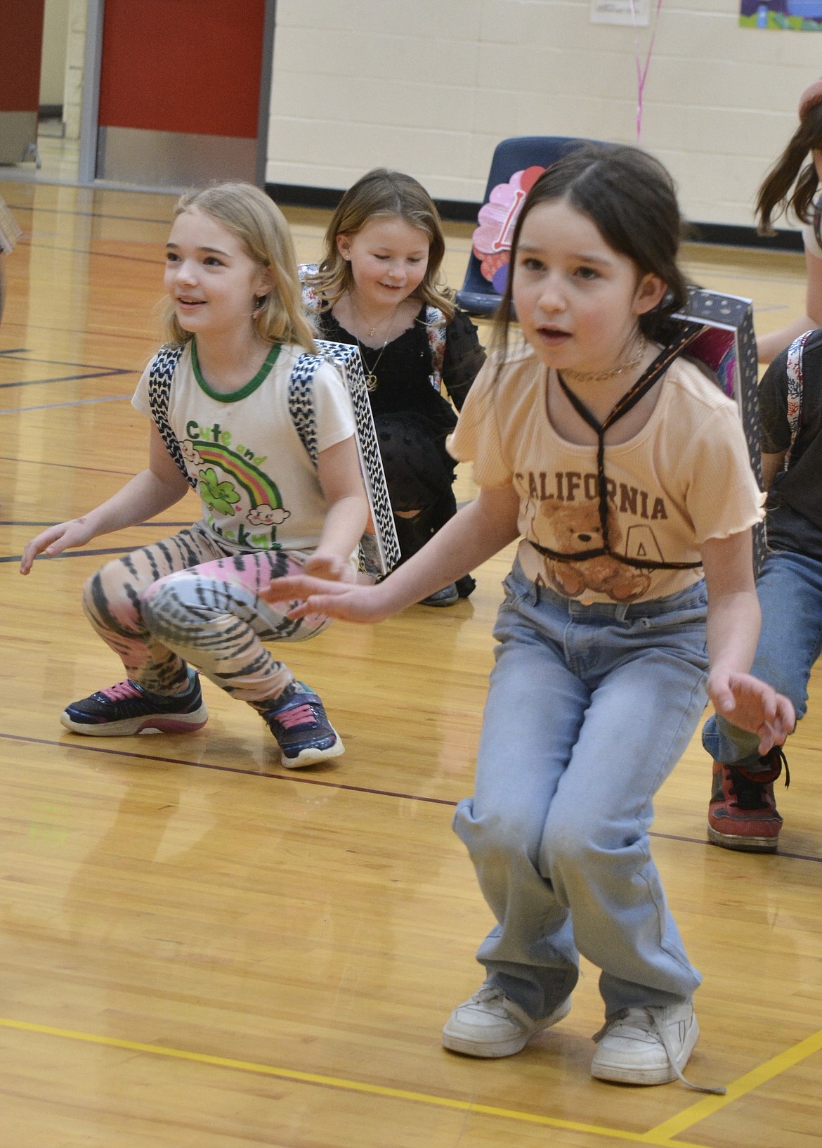 Second-graders Alora Williams, Harper Compton, and Khloe Petersen dance and sing during a special outer space concert at Bryan Elementary Wednesday.