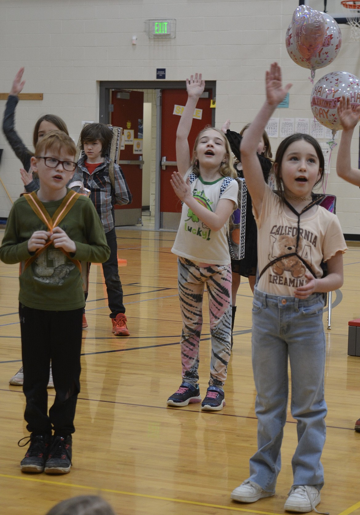 Brayden Hill, Rylenn Bennett, Alora Williams, and Khloe Petersen perform during a musical concert about the cosmos.