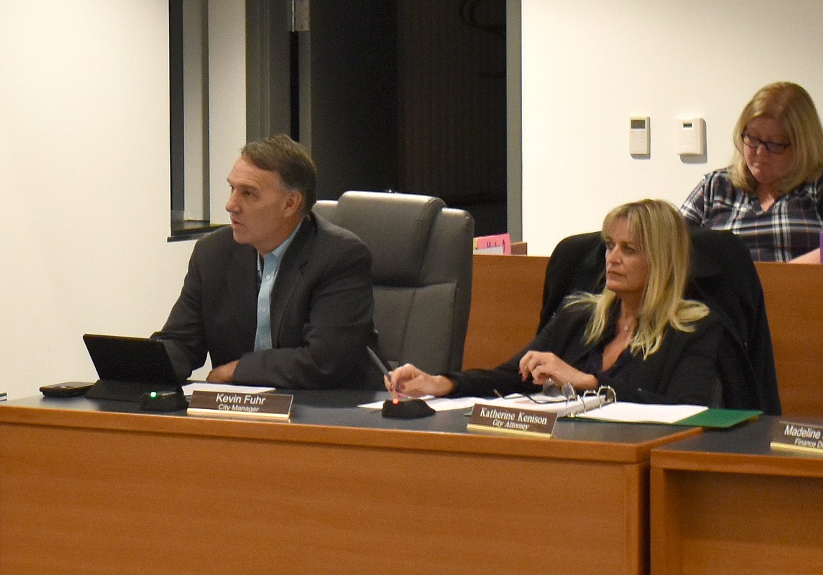 Moses Lake City Manager Kevin Fuhr, left, addresses the city council about the city’s financial position at the close of 2023.