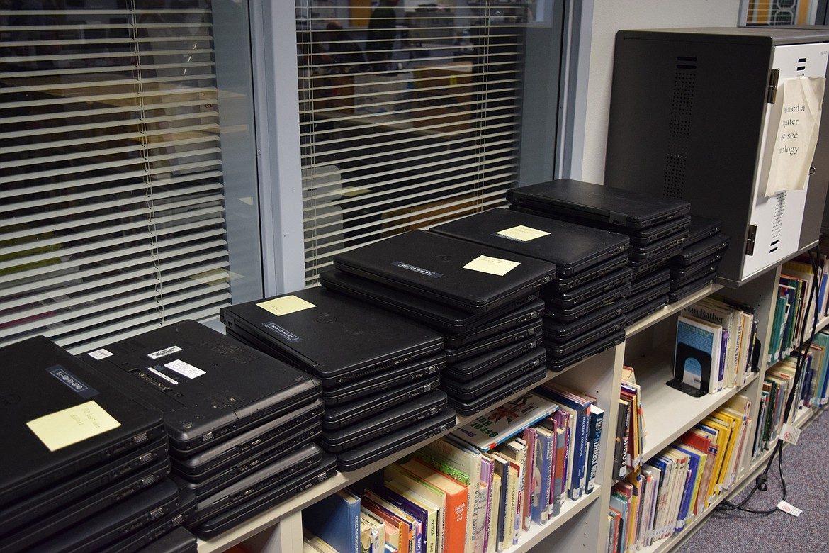 A row of computers is stacked next to a computer cart in Warden High School’s library. Warden School District will be purchasing 20 similar computers for its upcoming classes teaching parents how to access and navigate online resources, funded by a grant from the Washington Office of Superintendent of Public Instruction.