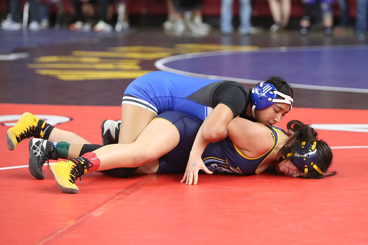 Warden senior Maira Zaragoza, top, is one of five Cougar girls wrestlers heading to Tacoma.