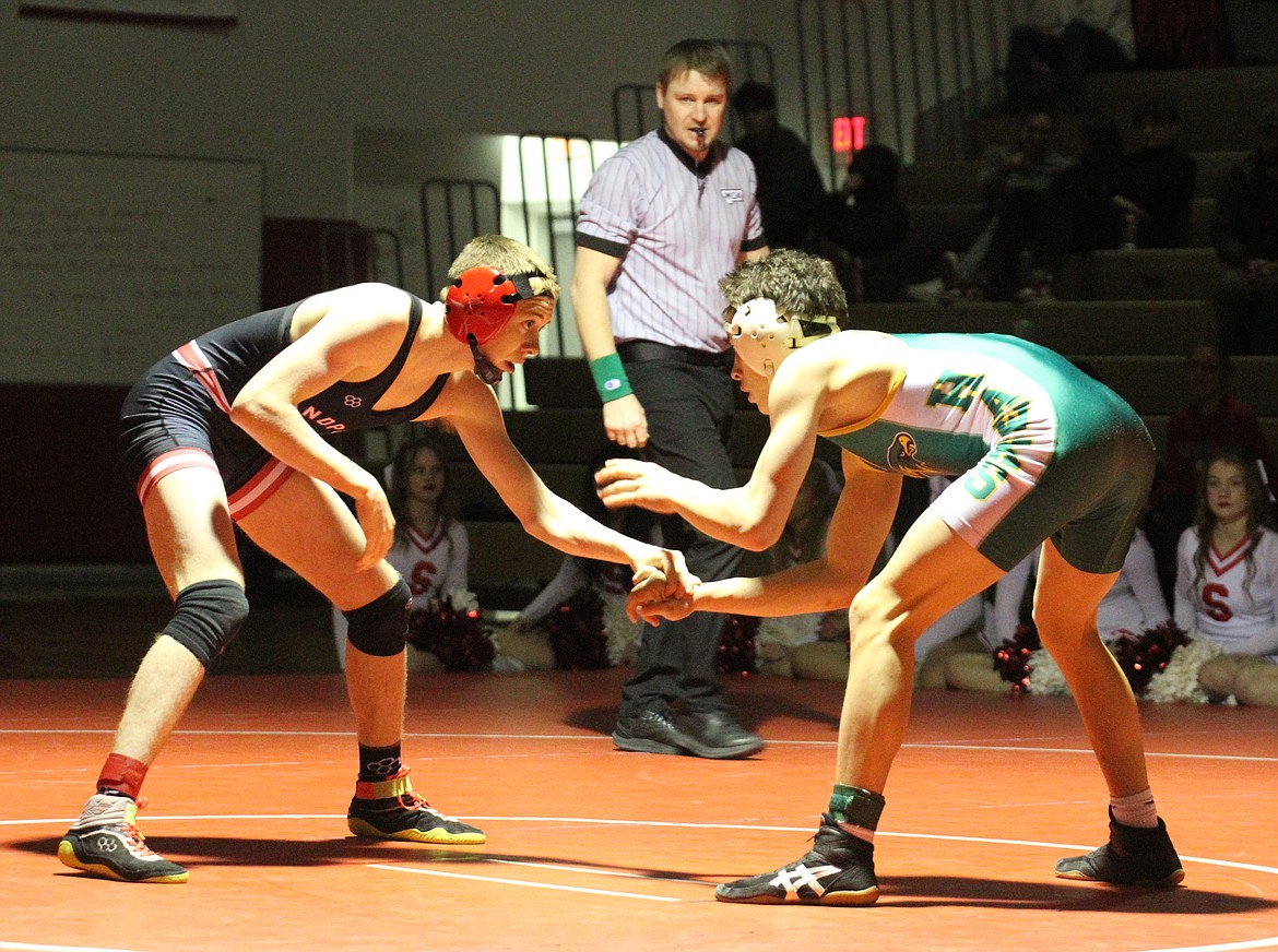 Sandpoint's Andrew Duke gets ready to make a move on Lakeland's Griffin Tamagni in the 126-pound district championship match.