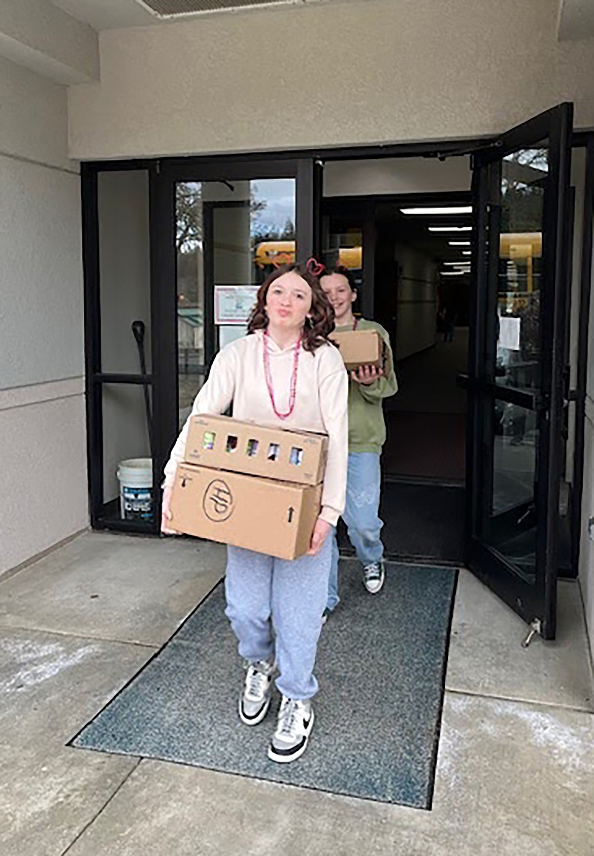 Hope students take the food they collected during the school's annual food drive out to a waiting school bus so that it can get to those in need.