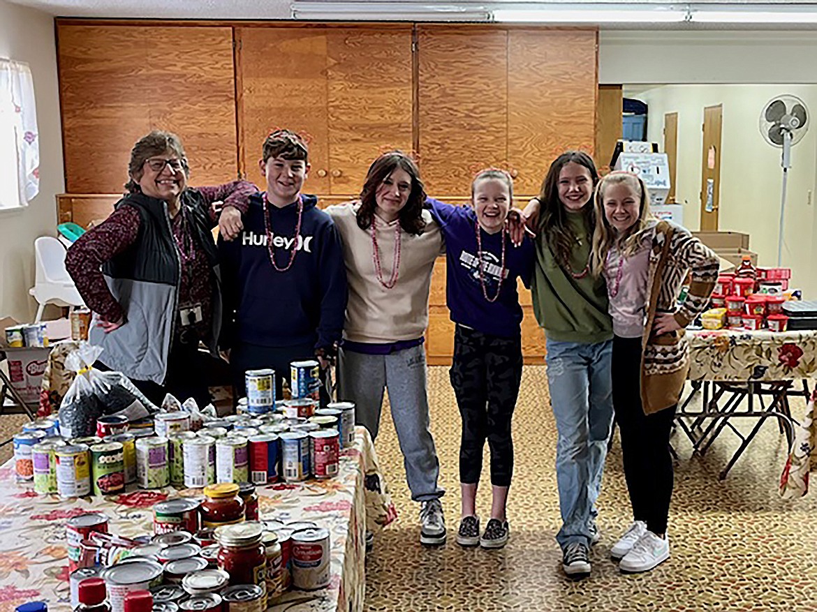 Hope students pose with some of the food they collected during the school's annual food drive.