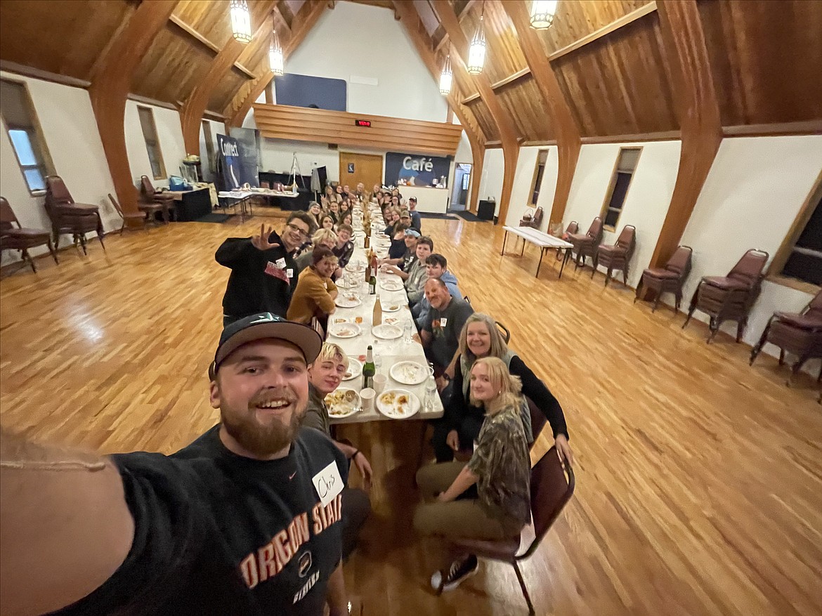 Young Life participants snap a selfie during dinner.