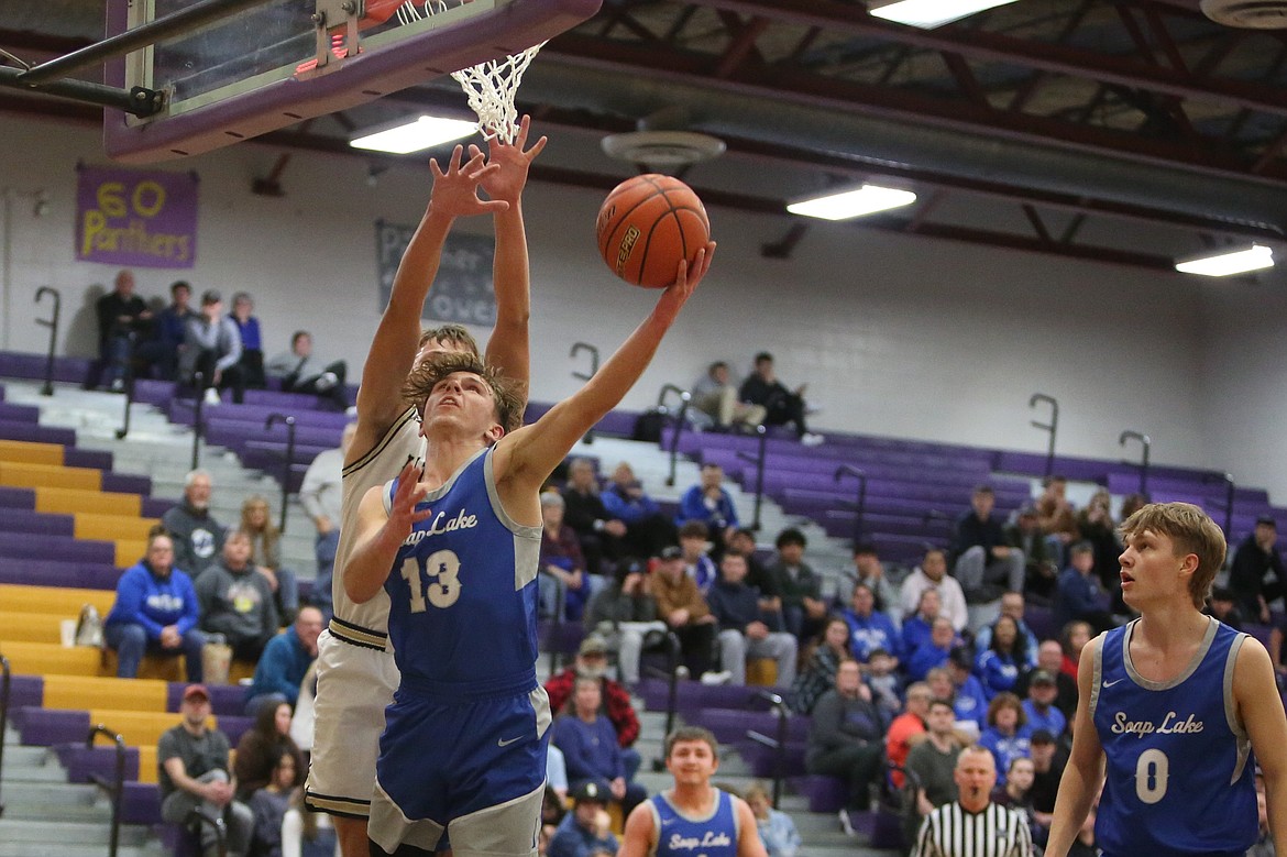 Soap Lake senior Andrey Sushik (13) attempts a lay-up in the second quarter against MLCA/CCS.