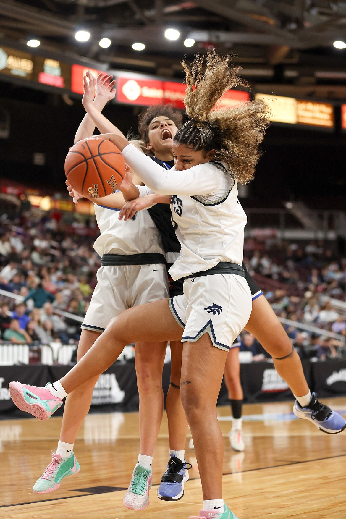 JASON DUCHOW PHOTOGRAPHY
Coeur d'Alene senior Teagan Colvin, center, and Lake City senior KaLiah Frazey meet in the lane in the state 5A girls basketball championship game Saturday night at the Ford Idaho Center in Nampa.