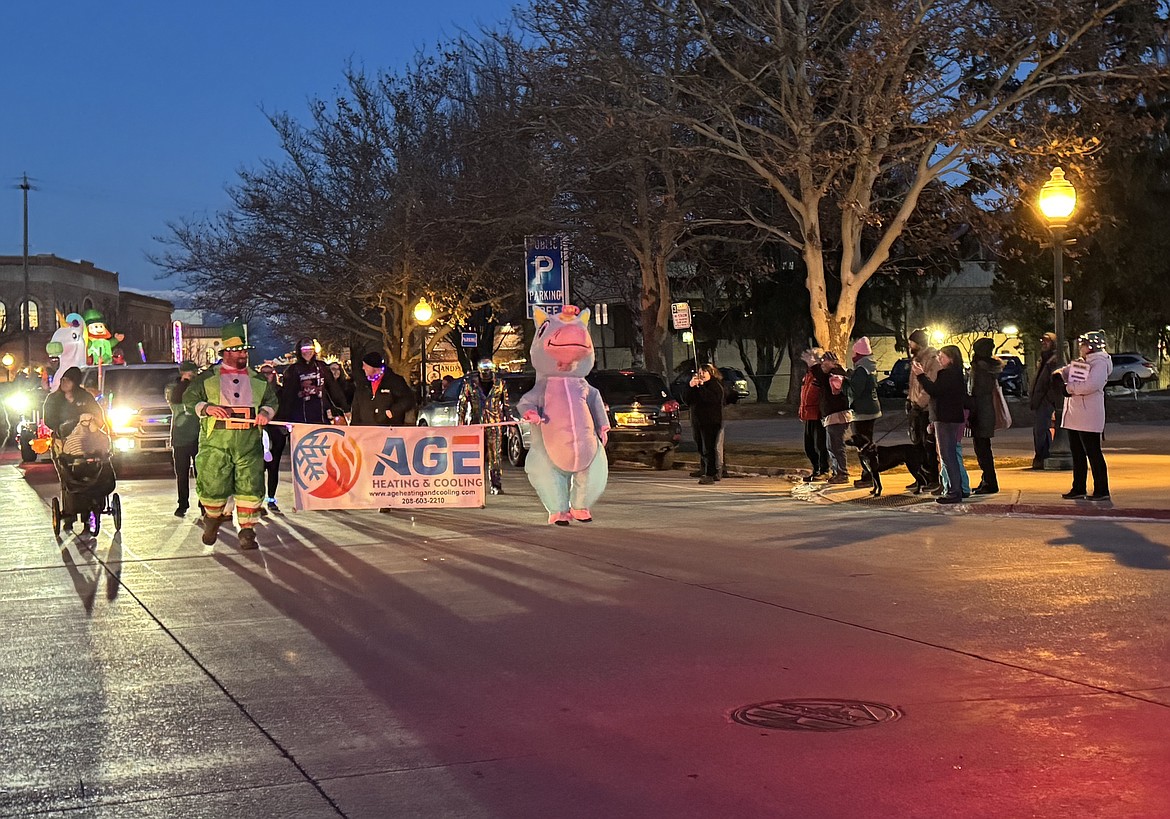 The AGE Heating and Cooling float makes its way down Oak Street near the city parking lot.