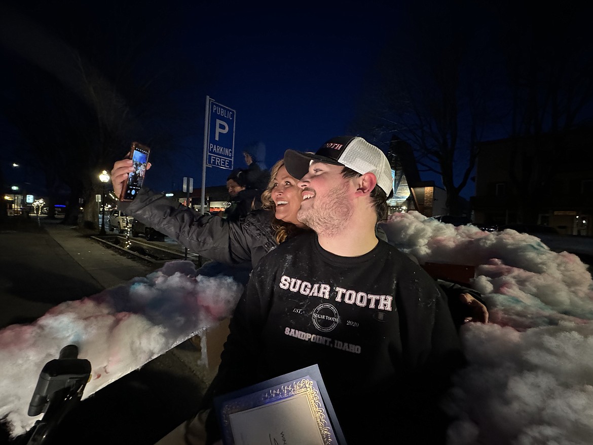 Payton Johnson and Marsha O'DellElliott take a selfie after the Sweet Tooth cotton candy-themed parade float won Most Original honors at Friday's Winter Carnival parade.