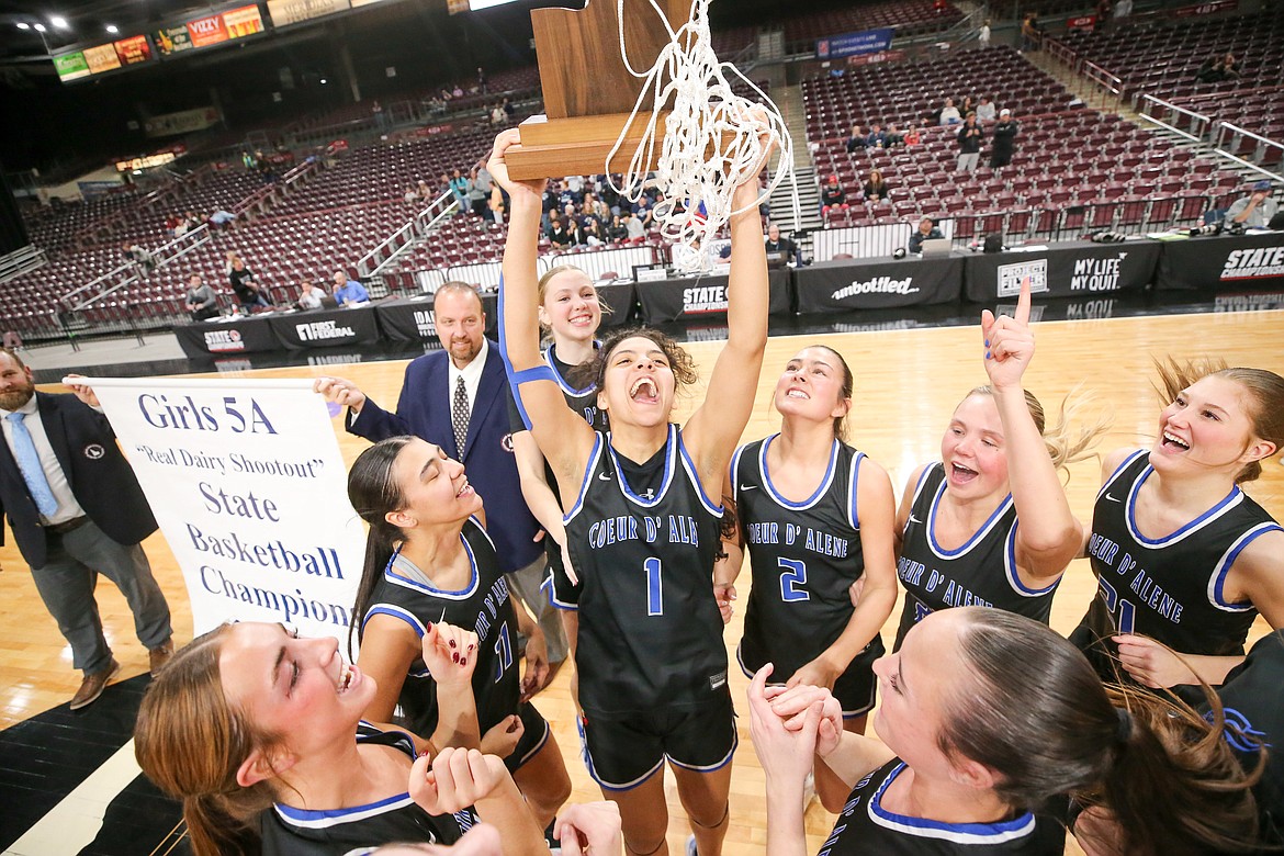 JASON DUCHOW PHOTOGRAPHY
Coeur d'Alene High senior Teagan Colvin (1) holds the trophy aloft as the Vikings celebrate after beating Lake City 58-49 in the state 5A girls basketball championship game Saturday night at the Ford Idaho Center in Nampa.