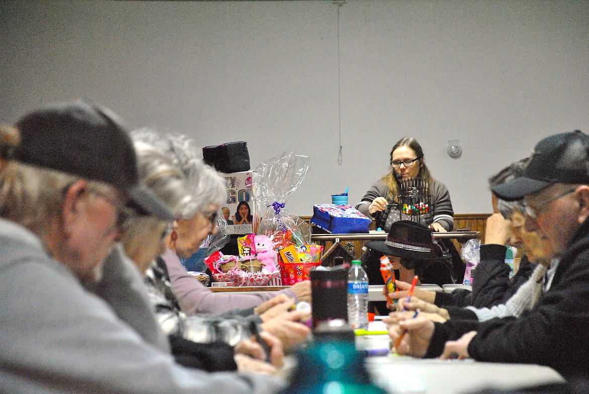 Angie Hopwood, was the caller for Bingo during last Monday's Pool in the Park Fundraiser at the St. Regis Community Center. Around 30 players gathered to dot bingo their cards and generate funds for a new pool in Superior. Winners had a wonderful variety of prizes and gift baskets to choose from donated by area businesses, and two black out card rounds had even bigger winnings. (Mineral Independent/Amy Quinlivan)