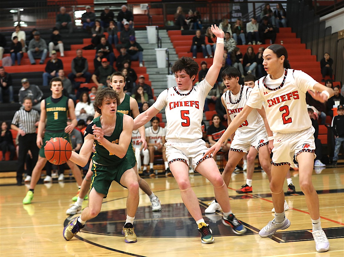 Chiefs Laurance Lozeau, Tayen Edmo and Sean Small work the defense in Saturday's win over the Whitefish Bulldogs. (Susan Lake photo)