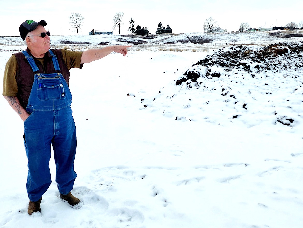 Kick Start Compost owner Bob Bell points to a compost pile that has no snow on it's top. That means it's "cooking", Bell said, and the temperature is up in the middle of the compost. (Berl tiskus/Leader)