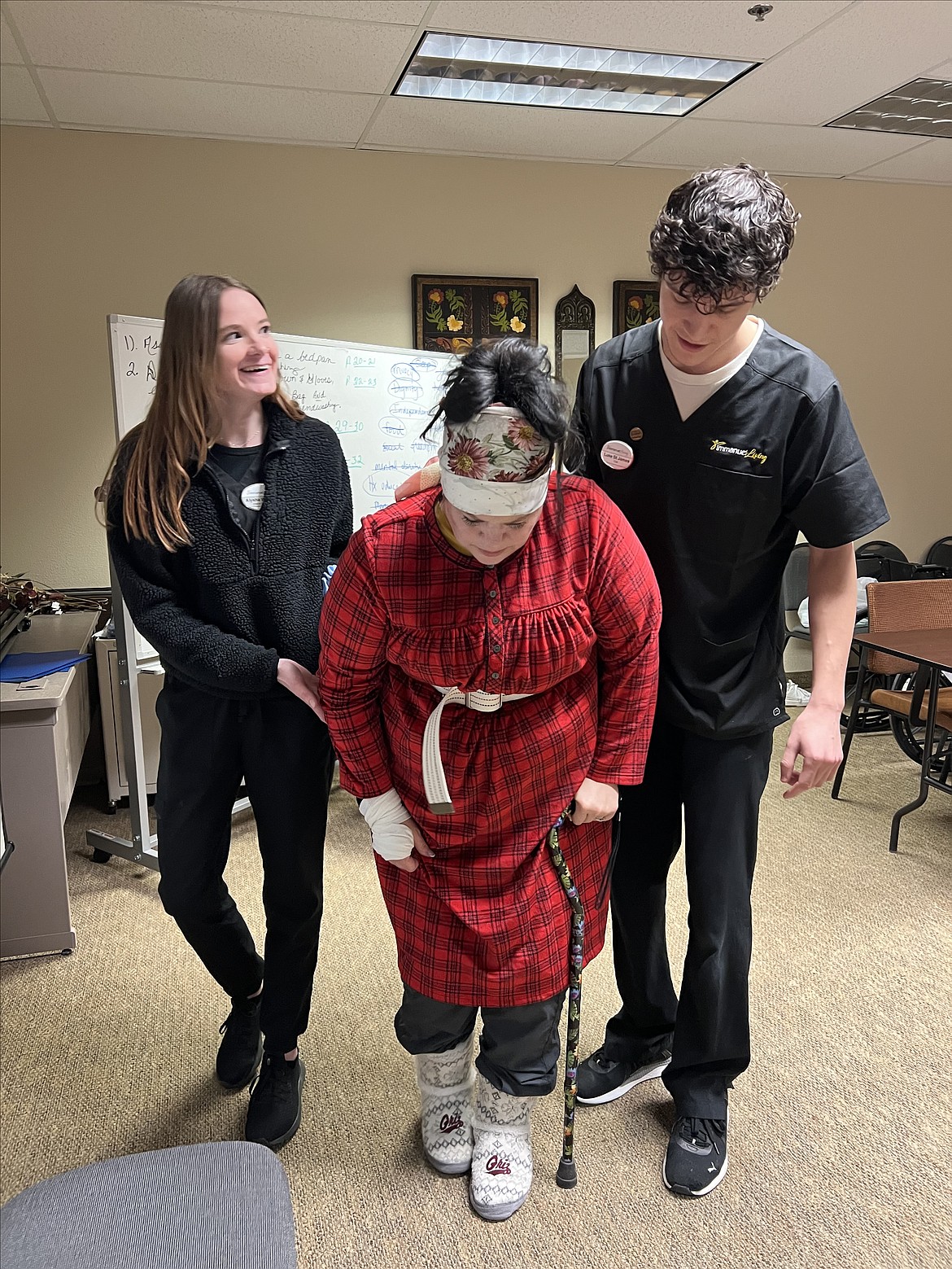 Immanuel Living Certified Nursing Assistant Luke St. James and CNA in training Alysha Wigner assist 'Martha' played by Simulation Specialist Charity Stephens during a Simulation in Motion Montana training scenario. (photo provided)