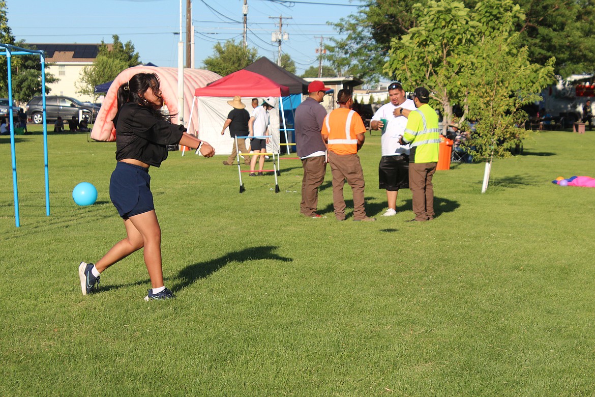 A volleyball player practices while adults congregate for conversation in Mattawa’s Hund Memorial Park in late July. Hund is one of Mattawa’s few parks or recreation locations in the city.