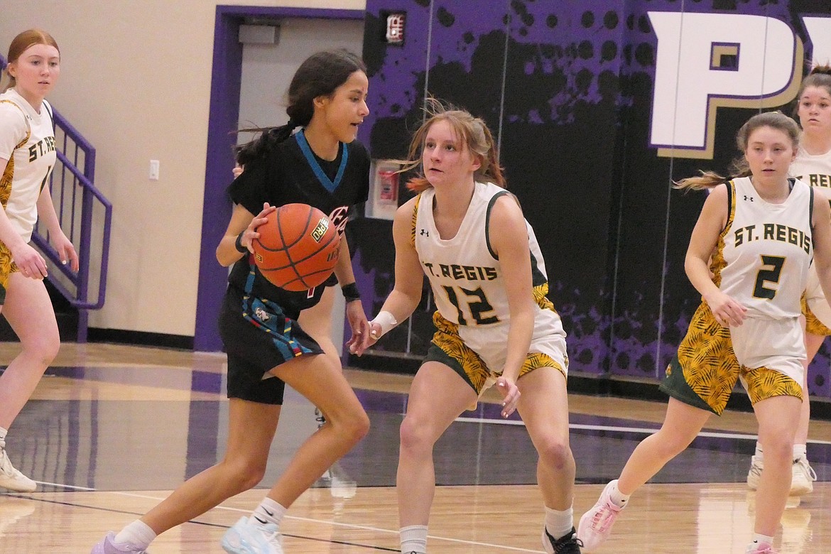 St Regis junior guard Kyla Bush (12) guards Two Eagle River's Dyani Piapot during their District 14C tournament game this past Saturday in Polson.  (Chuck Bandel/VP-MI)