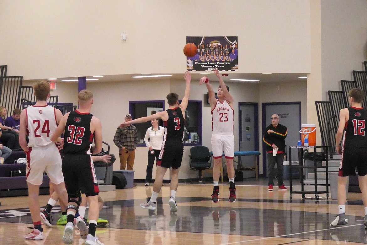 Noxon post Aiden Currie shoots over Hot Springs' Nick McAllister during their consolation final game at the District 14C tournament Saturday in Polson. (Chuck Bandel/VP-MI)