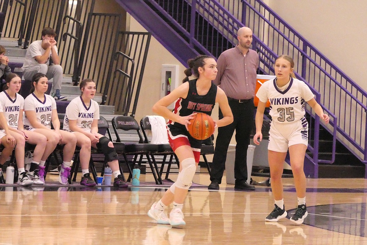 Hot Springs sophomore guard Kara Christensen looks for an open teammate under the watchful eye of Charlo's Brielle Zempel (35) during the game Saturday in Polson. (Chuck Bandel/VP-MI)
