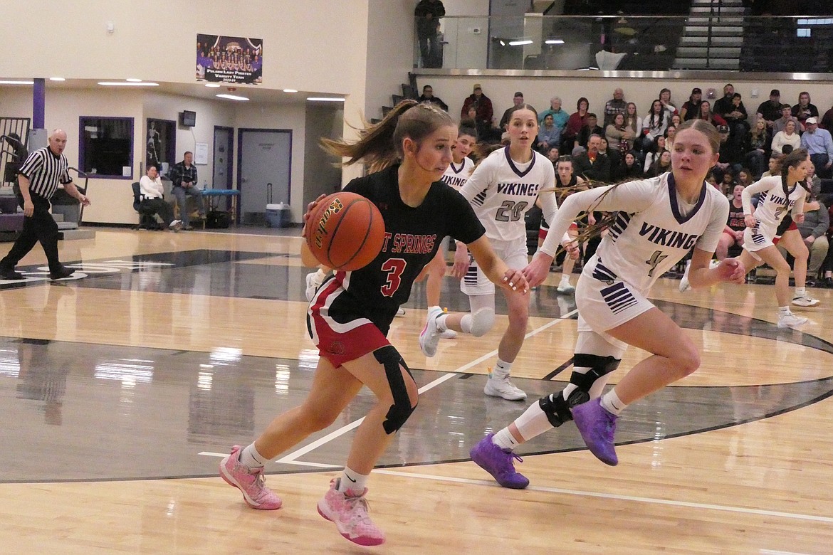 Hot Springs guard Callie Cano dribbles up court while being guarded by Charlo's Keadon Kain during their District 14C championship game Saturday evening in Polson. (Chuck Bandel/VP-MI)