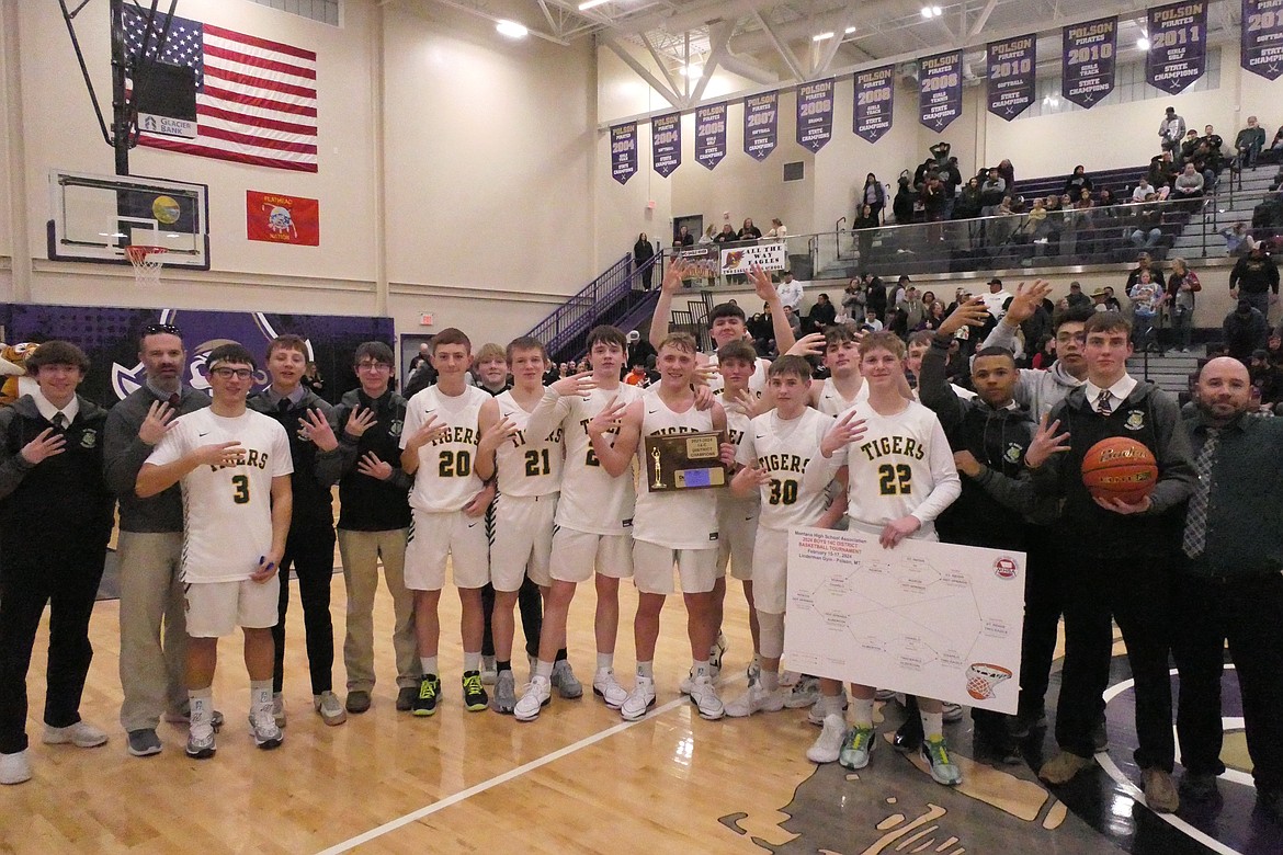 St. Regis players and coaches celebrate with their championship trophy after beating Two Eagle River Saturday night in Polson for the District 14C title. (Chuck Bandel/VP-NI)