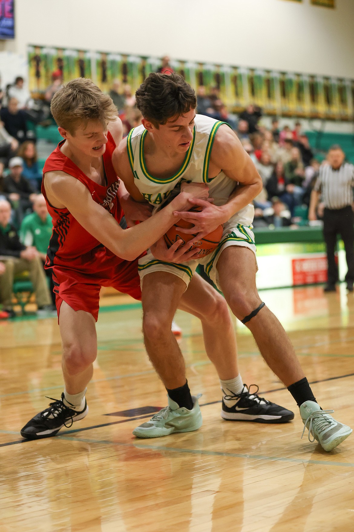 JASON DUCHOW PHOTOGRAPHY
Sandpoint freshman Derrick Chamberlain, left, and Lakeland senior Ben Roth fight for the ball during a 4A Region 1 tournament game Monday night at Hawk Court in Rathdrum.