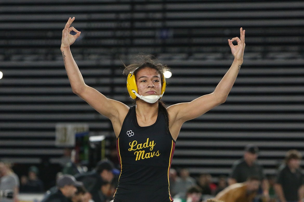 Moses Lake senior Ashley Naranjo holds up three fingers in each of her hands after winning her third straight state championship at the 3A/4A Girls Mat Classic in Tacoma.