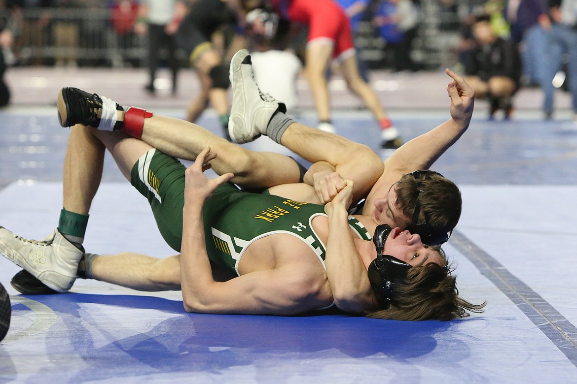 Othello sophomore Mason Russell, background, pins his opponent during a match at the 2A Boys Mat Classic in Tacoma.