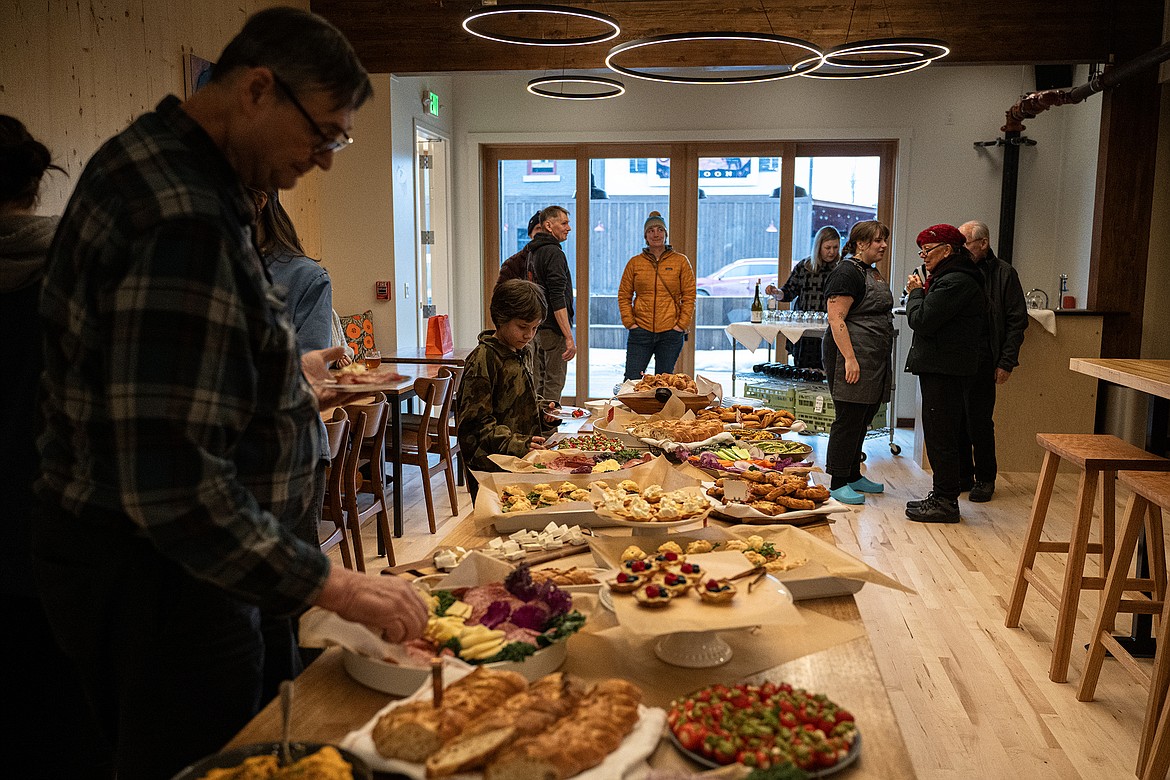 Guests tour the new Uptown Hearth building and try out their food during the sneak peek preview party Thursday, Feb. 15. (Avery Howe photo)