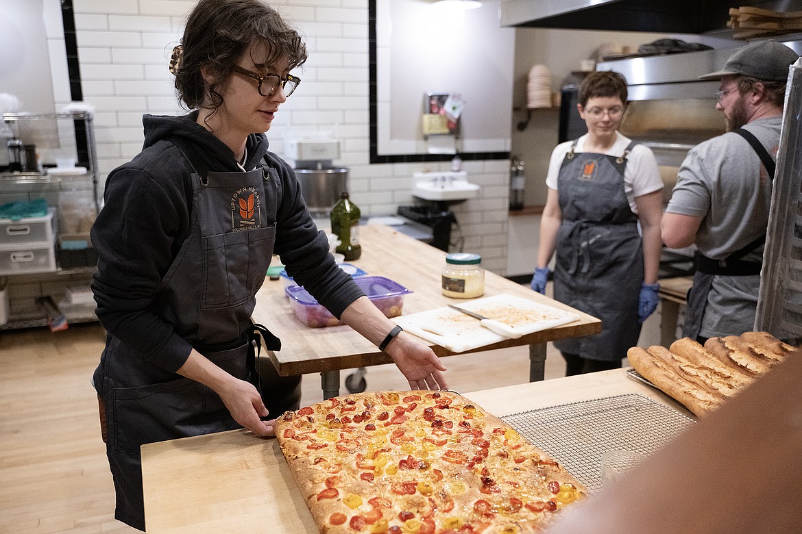 The Uptown Hearth staff works on creating focaccia for their guests at the Sneak Peak Preview Party Thursday, Feb. 15. (Avery Howe photo)