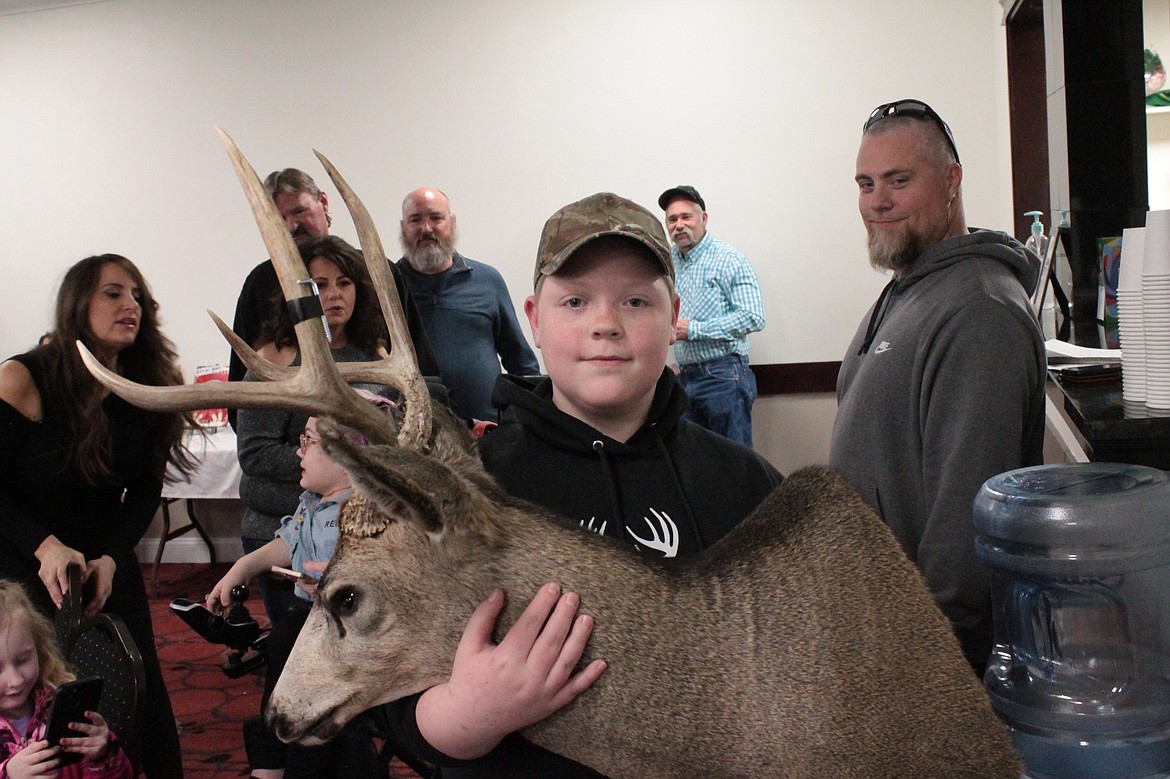 Aiden Wilsey displays the trophy head of the buck he harvested in 2022 with Youth Outdoors Unlimited at the 2023 benefit auction. This year’s event is March 2.