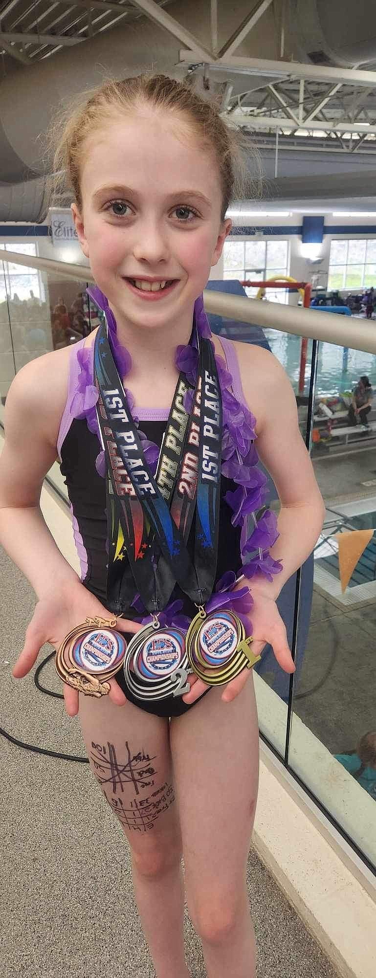 Sandpoint's Charlie Johnson shows off some of the medals she won at the 2024 Inland Empire Short Course Junior Championships.