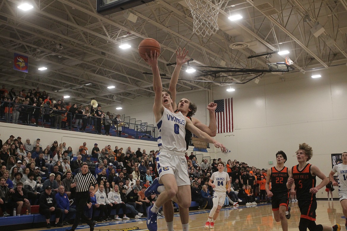 MARK NELKE/Press
Gunner Larson (0) of Coeur d'Alene goes up for a shot as Alex Shields of Post Falls defends during the 5A Region 1 championship game Tuesday night at Viking Court.