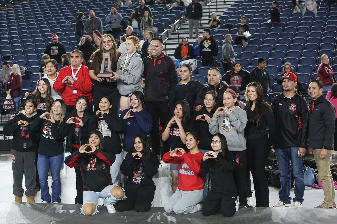 Othello wrestlers pose for photos after placing fourth in the 2A/1A/B Girls classification at the Mat Classic in Tacoma.