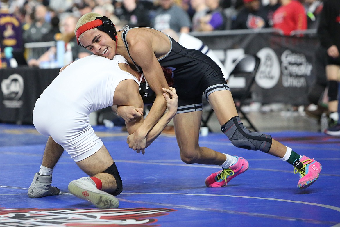 Othello sophomore Daniel Gonzalez, right, wrestles in the 2A 113-pound third/fourth-place match at the Tacoma Dome. Gonzalez was one of seven Othello boys wrestlers that placed in the tournament.