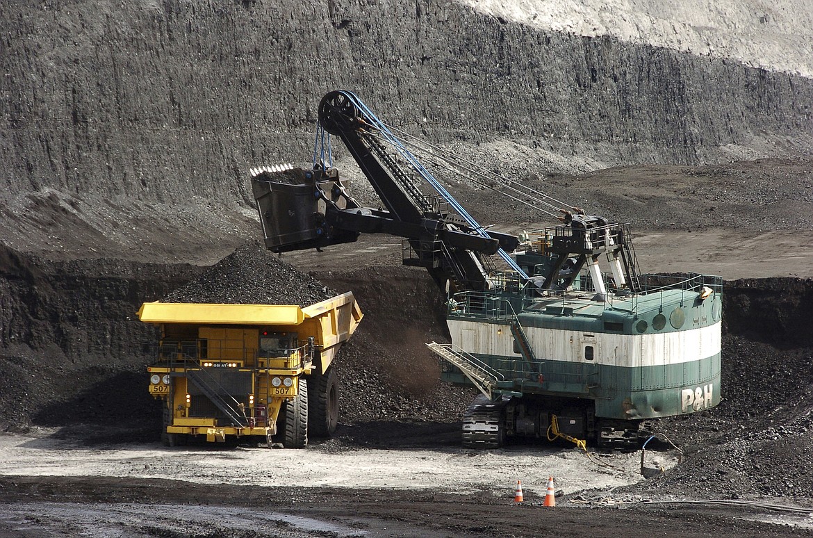 A mechanized shovel loads a haul truck that can carry up to 250 tons of coal at the Spring Creek coal mine, April 4, 2013, near Decker, Mont. On Wednesday, Feb. 21, 2024, a U.S. appeals court struck down a judge's 2022 order that imposed a moratorium on coal leasing from federal lands. (AP Photo/Matthew Brown, File)