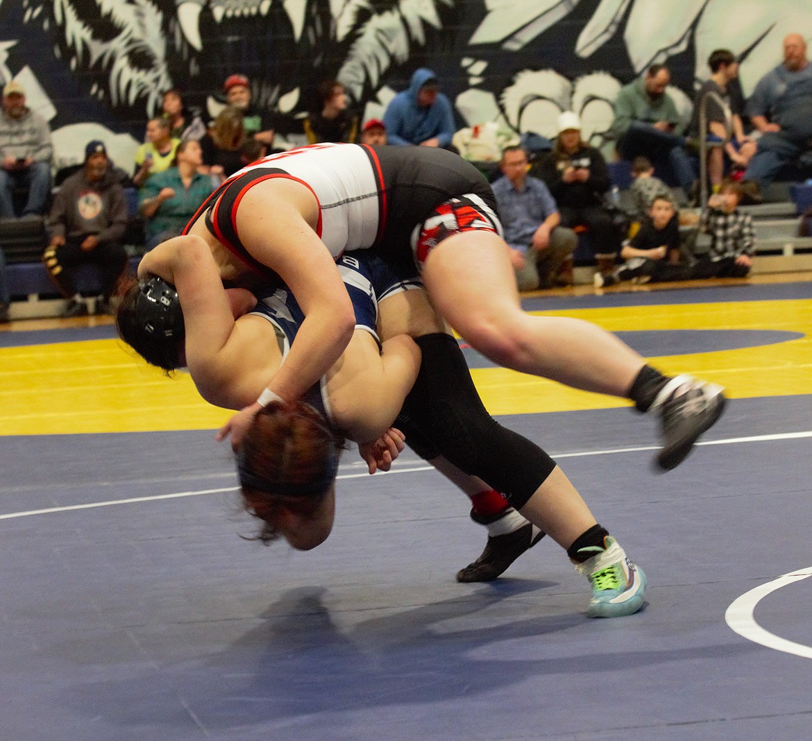 Aubrey Wells flips Sandpoint's Sylvia Becker at the Girls Districts I-II on Feb. 15.