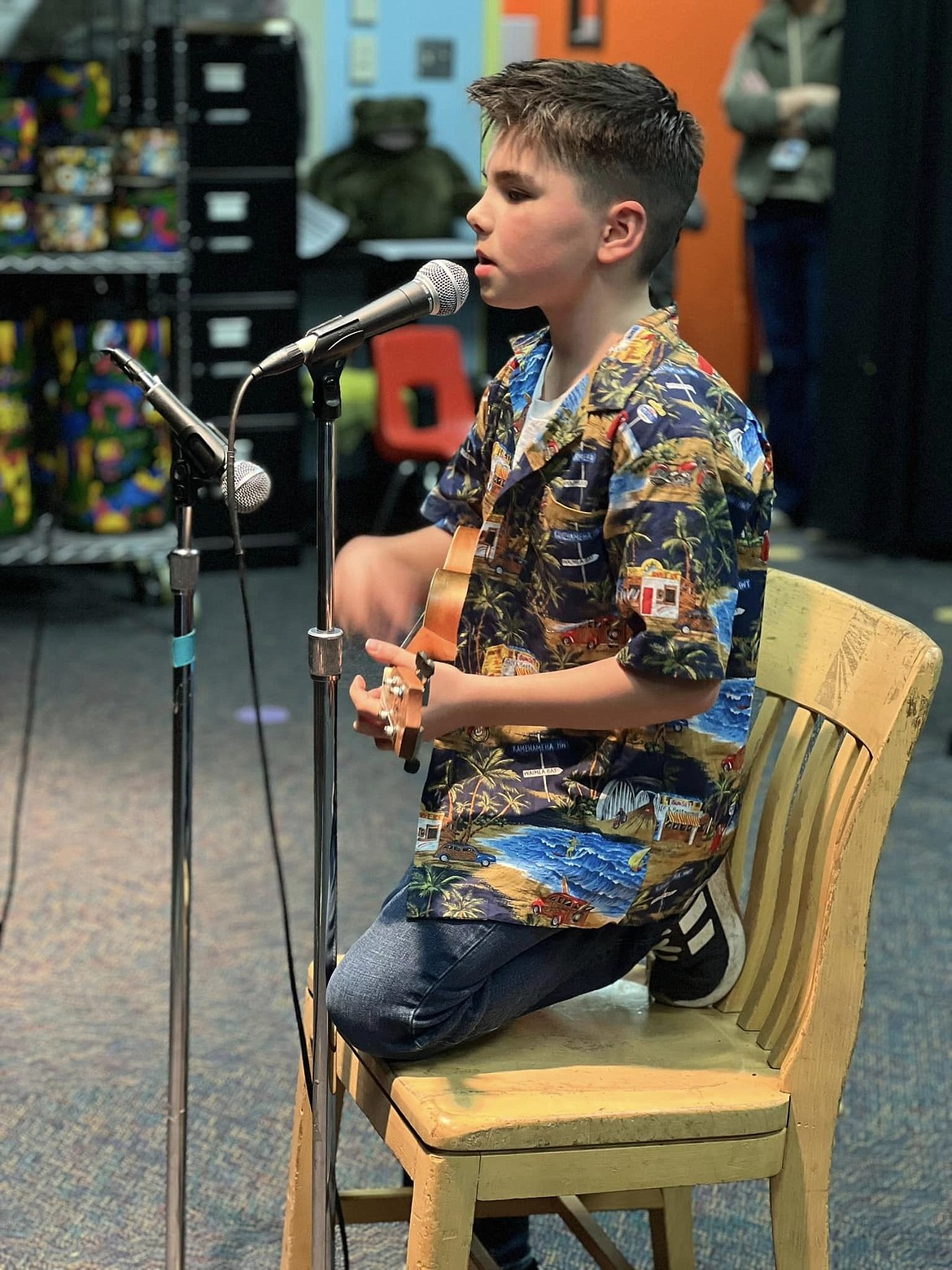 A student sings and plays the guitar during the Grant Elementary School talent show. The show is likely to come back again next year after a successful event this school year.