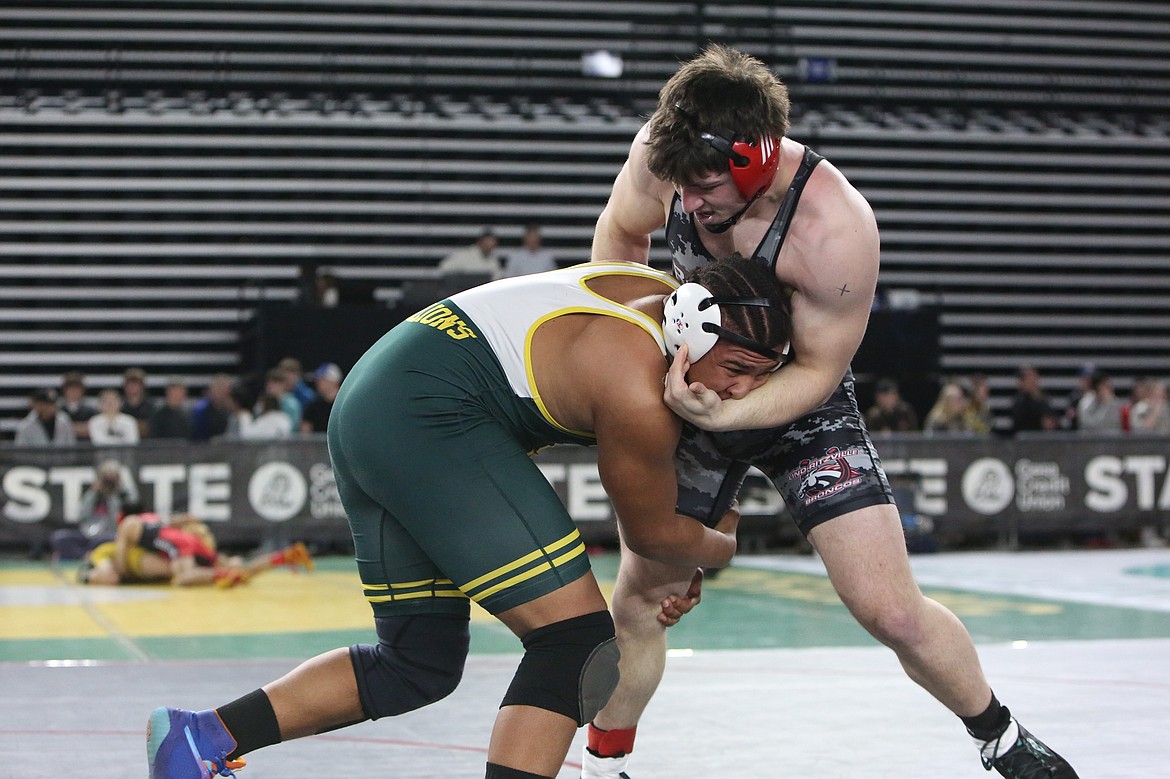 Lind-Ritzville/Sprague senior Game Smith, right, wrestles against Liberty Bell’s Damien Spears, left, in the semifinals of the 1B/2B 215-pound class. Smith avenged a loss to Spears from earlier in the season with a 5-2 decision to advance to the state finals.