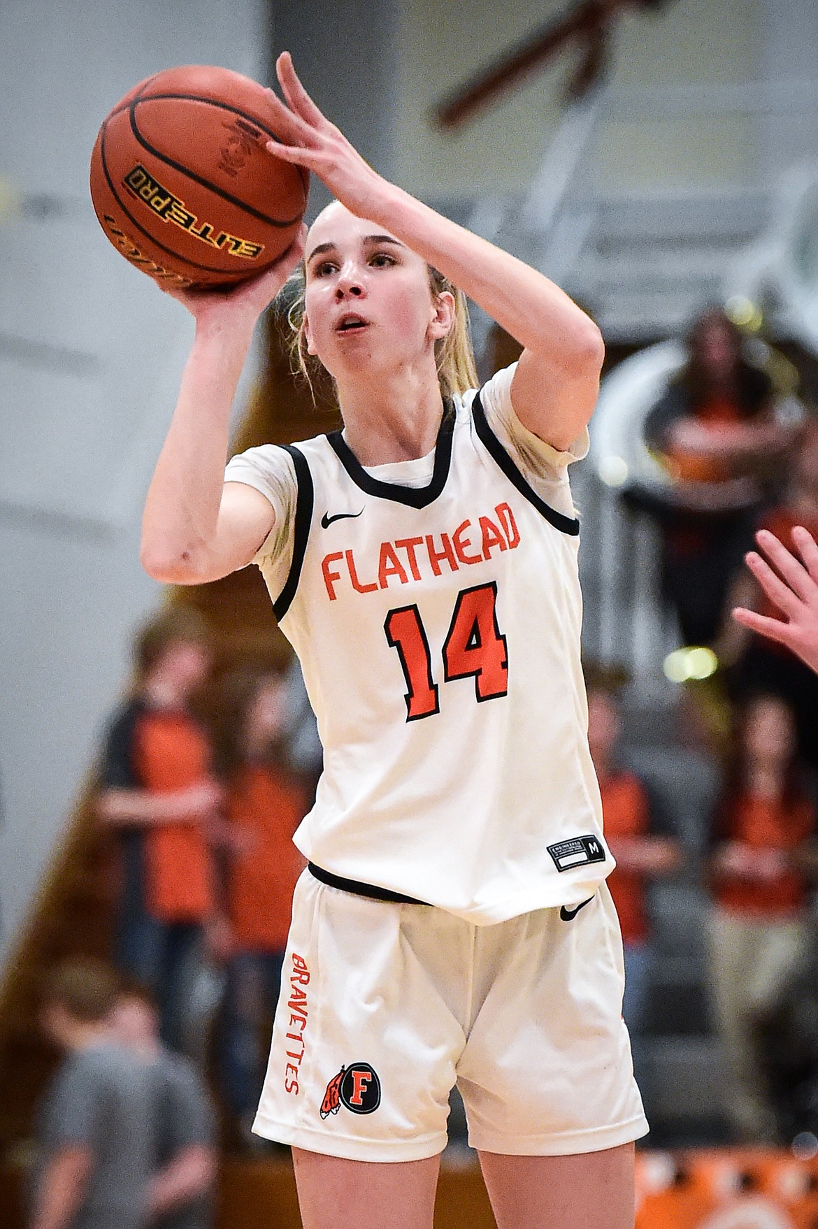 Flathead's Kennedy Moore (14) knocks down a three in the first half against Missoula Hellgate at Flathead High School on Thursday, Feb. 22. (Casey Kreider/Daily Inter Lake)