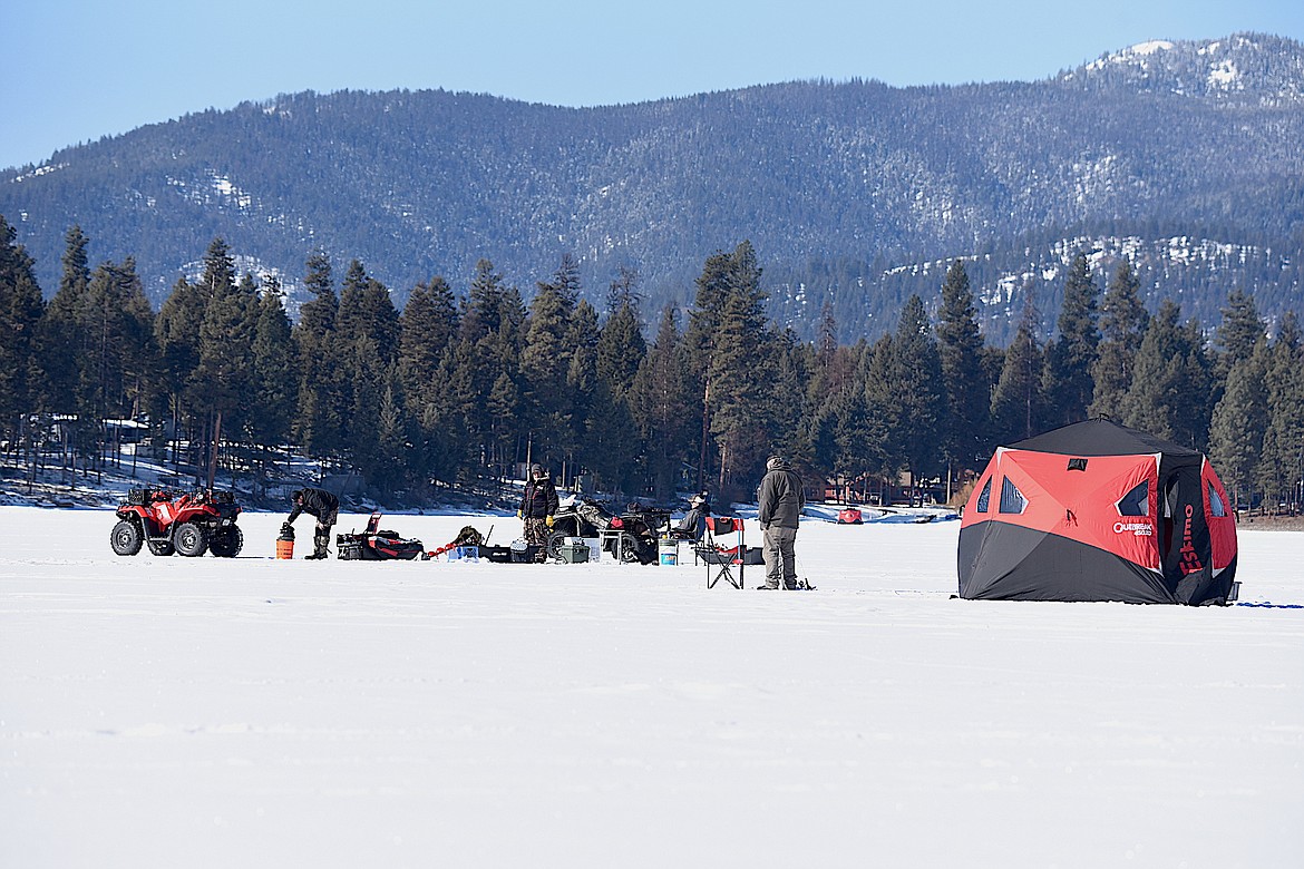 Anglers tend to their lines Saturday, Feb. 17, 2024, on Crystal Lake during the Fisher River Fire Rescue Auxiliary Fish Derby. See related story and results on Page A3. (Scott Shindledecker/The Western News)
