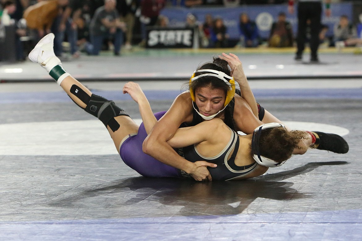 Moses Lake senior Ashley Naranjo, top, wrestles against Lake Stevens’ Kamryn Mason, bottom, in the 3A/4A Girls 110-pound finals at the Mat Classic in Tacoma.