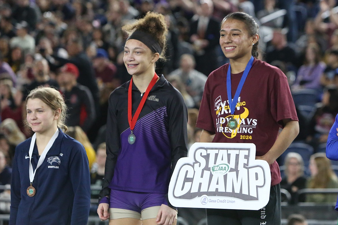 Moses Lake senior Ashley Naranjo, right, stands on the podium at the Mat Classic. Over the course of her career, she’s stood with champions several times.