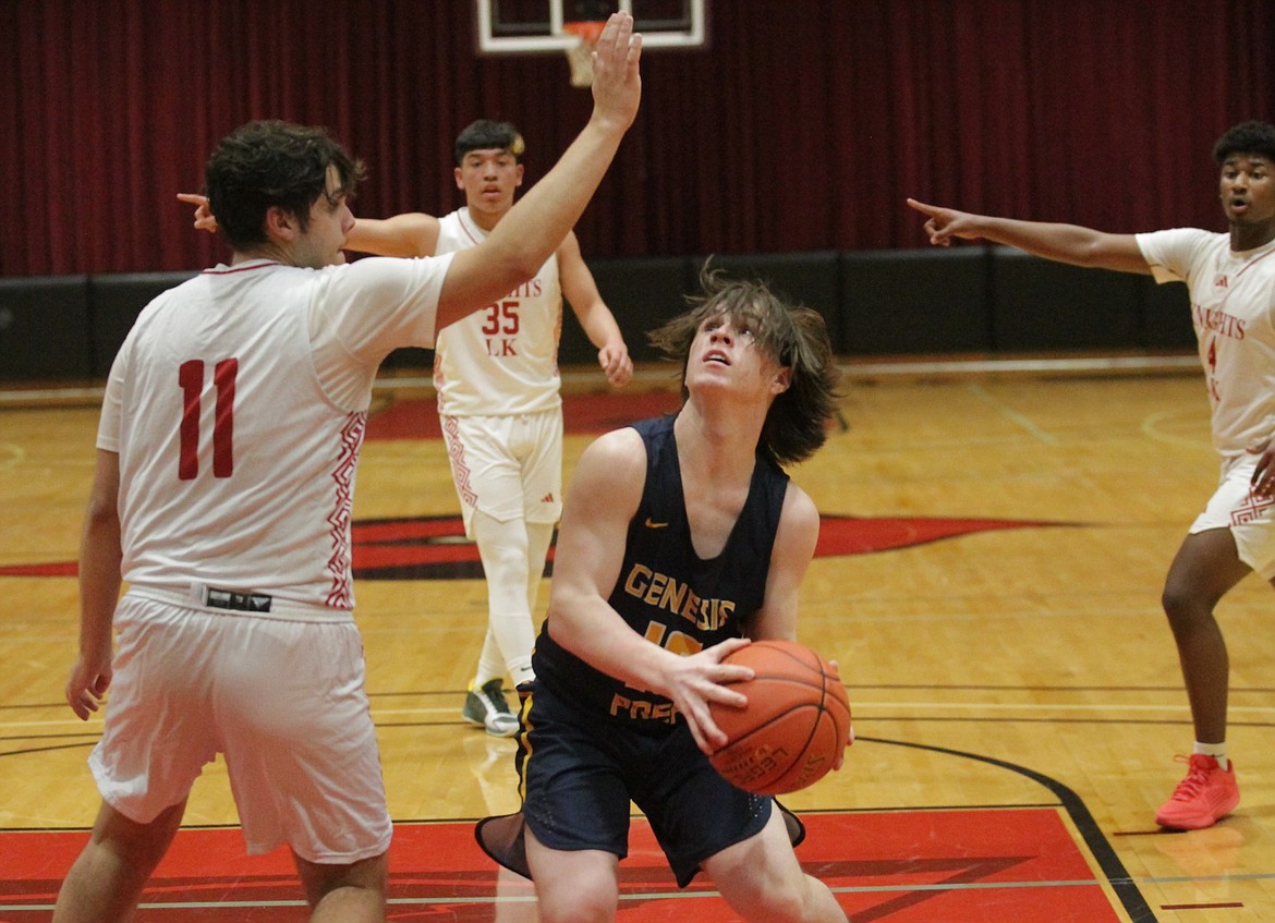 MARK NELKE/Press
Genesis Prep junior Isaiah Bateman (13) looks to shoot as senior Liam Hendrickx (11) of Lakeside defends in the 1A Division I District 1 championship game Thursday at North Idaho College.