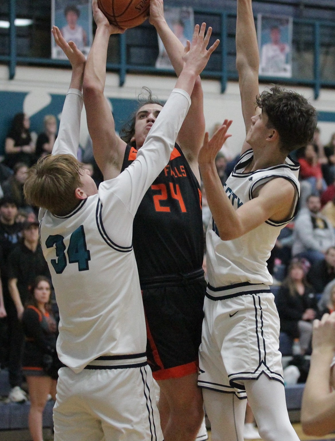 MARK NELKE/Press
Post Falls senior Alex Shields puts up a shot as Jordan Carlson, left, and Carter Kloos of Lake City defend in the 5A Region 1 second-place game Thursday at Lake City.