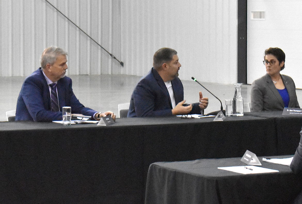 From left: Grant PUD General Manager Rich Wallen, Grant County Economic Development Council Director Brant Mayo and Big Bend Community College President Sara Thompson Tweedy discuss the county’s diverse economy at the round table meeting Thursday at Sila Nanotechnologies.